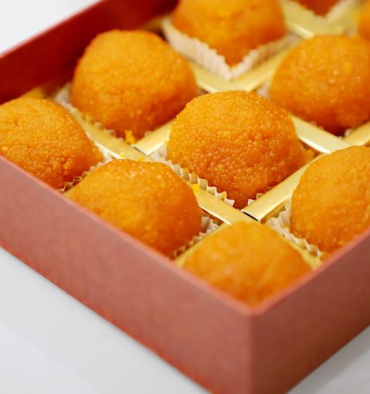 Close-up of Indian laddoo sweets elegantly arranged in a box, perfect for festive treats.